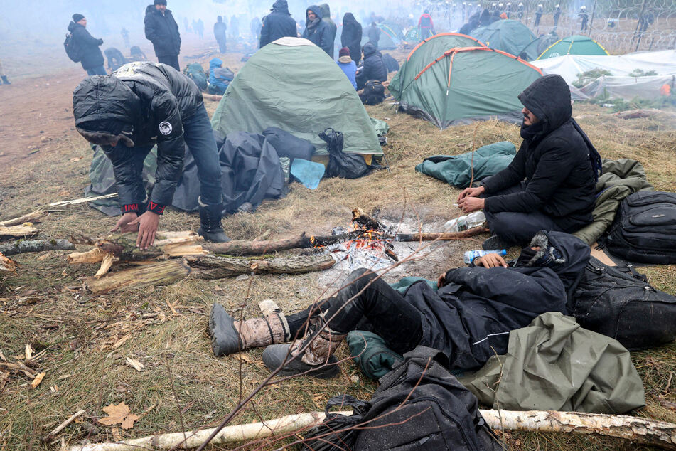 Ausharren bei eisiger Kälte: Migranten versammeln sich an der belarussisch-polnischen Grenze an einem Feuer, um sich zu wärmen.