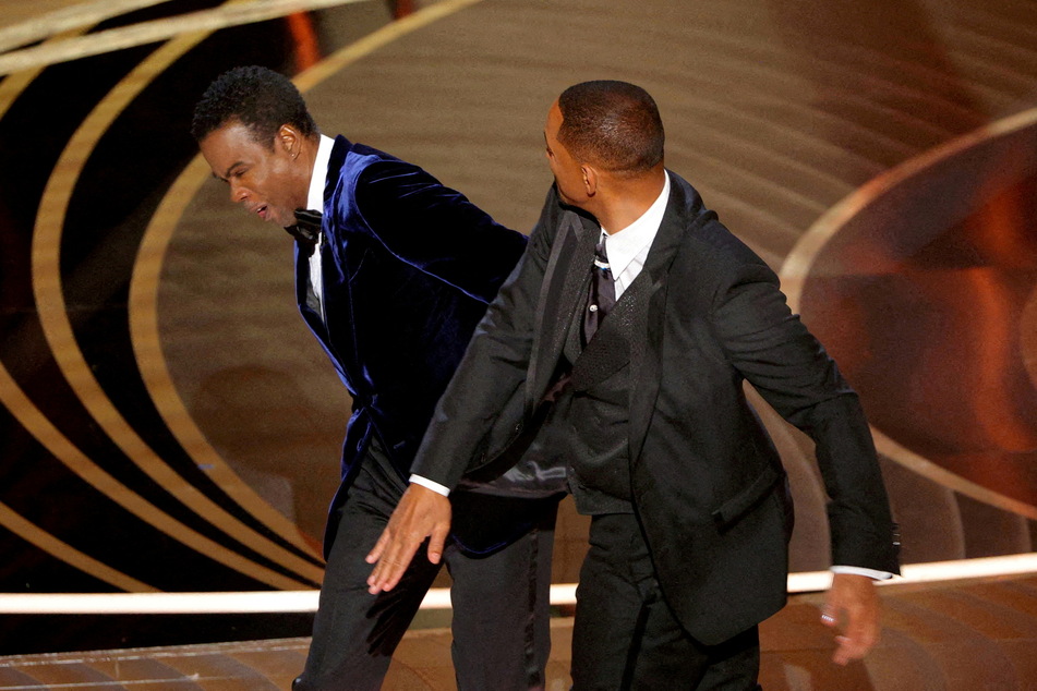At the 2022 Oscars, Will Smith (r) slapped Chris Rock (l) after the comedian made a joke about Smith's wife, Jada Pinkett-Smith.