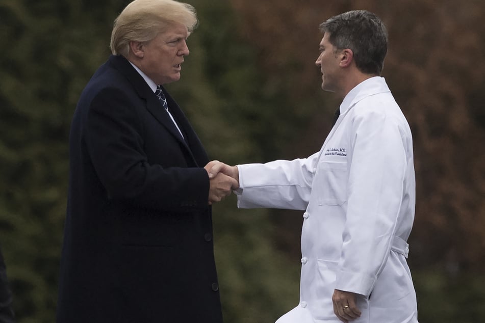 Then-President Donald Trump (l.) shakes hands with White House Physician Rear Admiral Dr. Ronny Jackson (r.), following his annual physical at Walter Reed National Military Medical Center in Bethesda, Maryland, January 12, 2018.