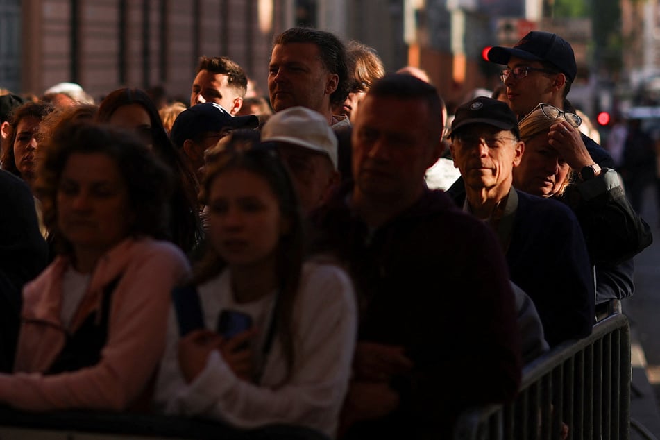 People line up to enter St. Peter's Square on the second day of the conclave to elect the new pope at the Vatican on May 8, 2025.