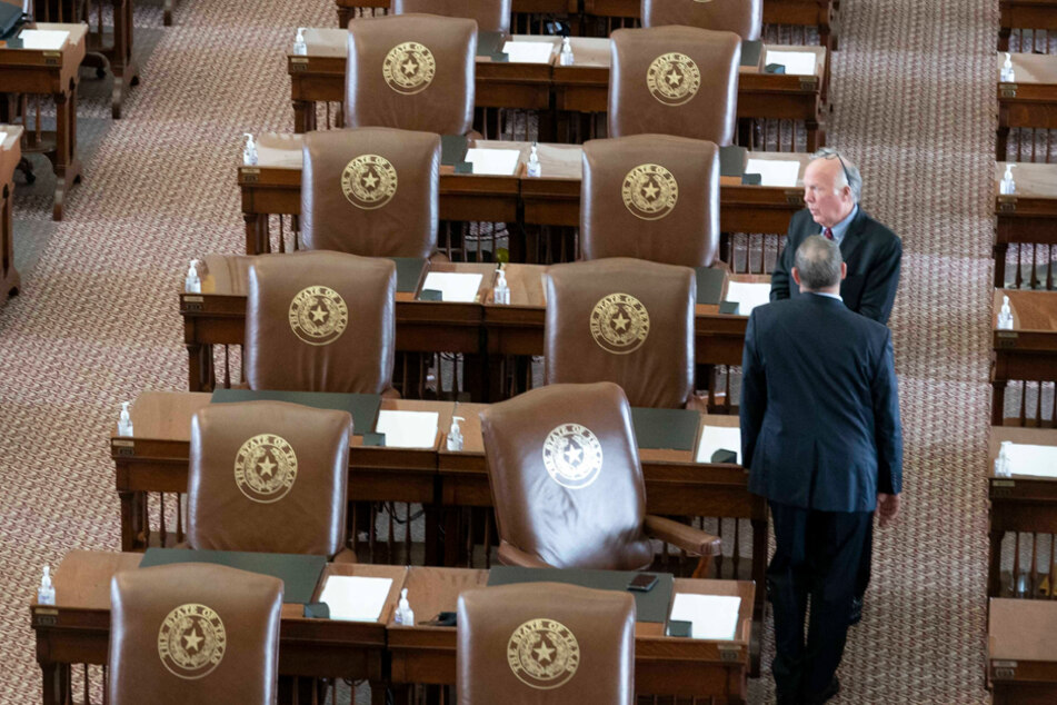 Rep. Todd Hunter, who drafted HB-1, speaks with a colleague at the Texas House of Representatives Chamber on May 30 in Austin, Texas.
