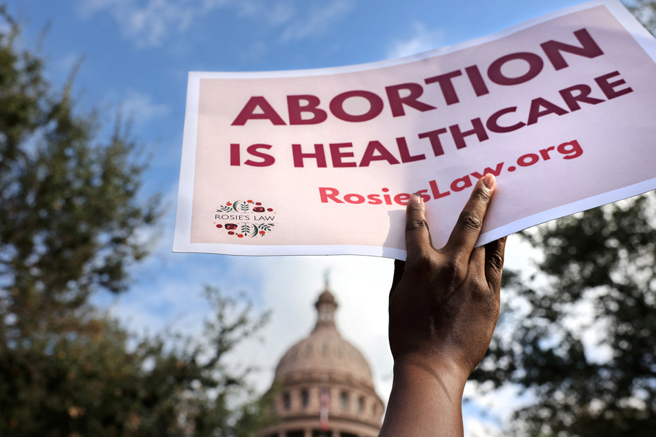 An abortion rights advocate holds a sign outside the Texas State Capitol building during the nationwide Women's March, in Austin, Texas, U.S. October 2, 2021.