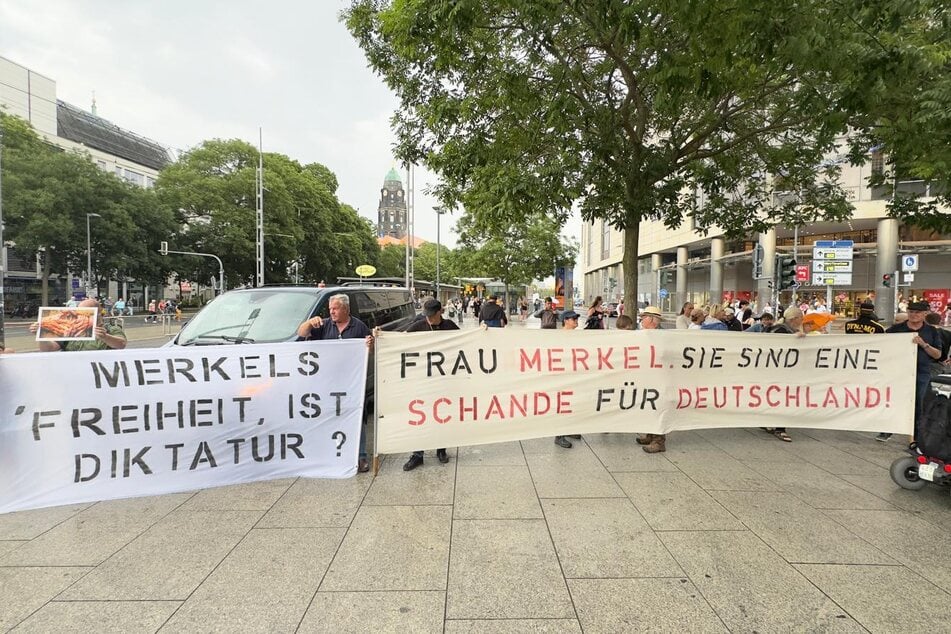 Gegner von Angela Merkel brachten ihren Unmut auf Transparenten zum Ausdruck.