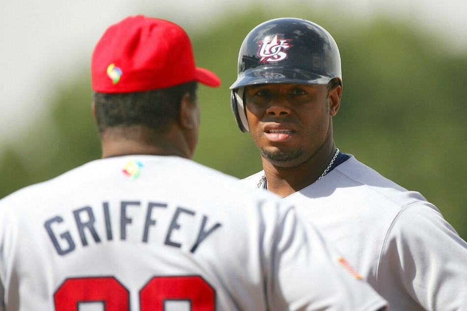 Ken Griffey Jr. (r.) of Team USA talks with his father Ken Griffey Sr. (l) at first base during a Game of the World Baseball Classic against Team South Africa.