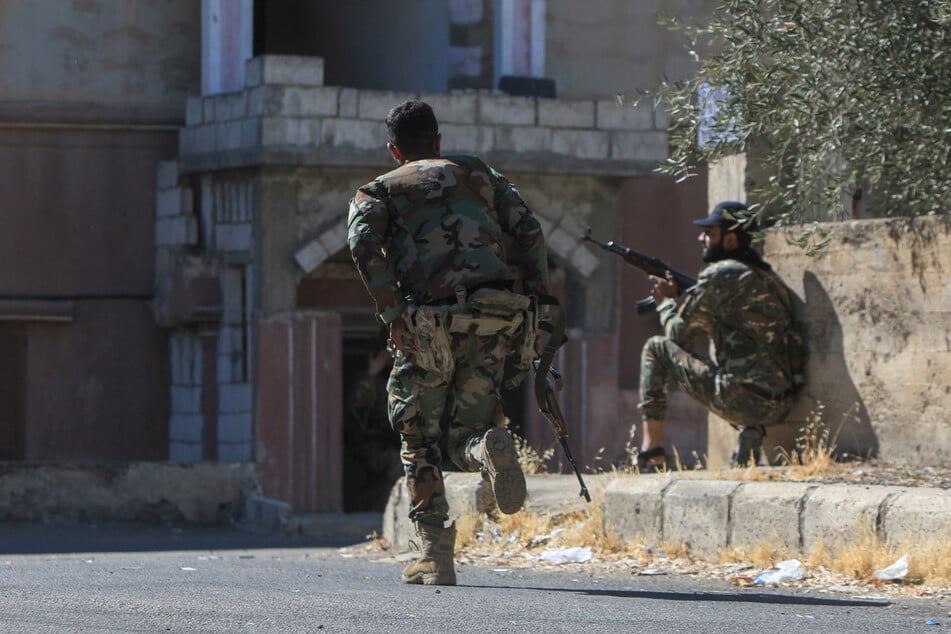 Syrian security forces take position amid ongoing clashes in the southern city of Sweida on Wednesday.