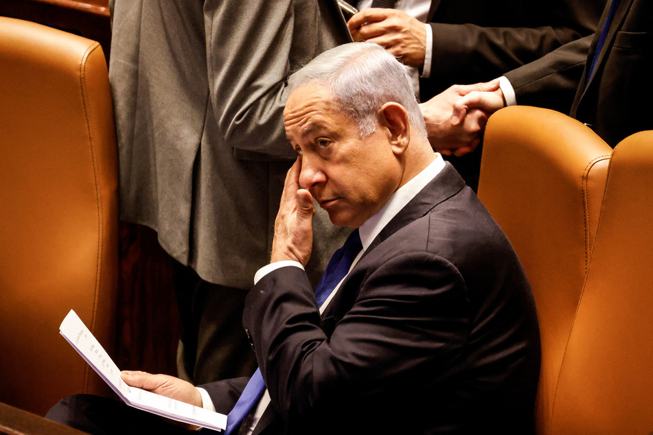 Israeli Prime Minister Banjamin Netanyahu looks on as Israeli lawmakers vote on a bill that would limit some Supreme Court power.