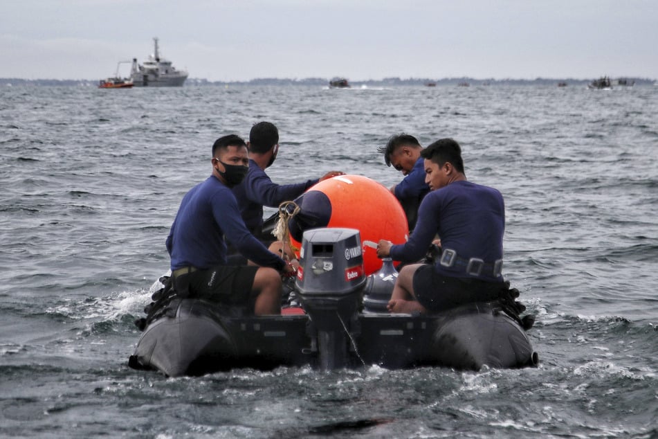 Taucher der indonesischen Marine nehmen an der Suche nach dem abgestürzten Jet der Sriwijaya Air in den Gewässern vor der Insel Java teil.