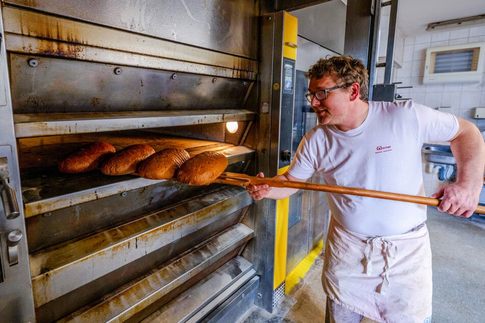 Silvio Werner (44) holt in seiner Backstube in der Markersdorfer Straße frische Brote aus dem Ofen.