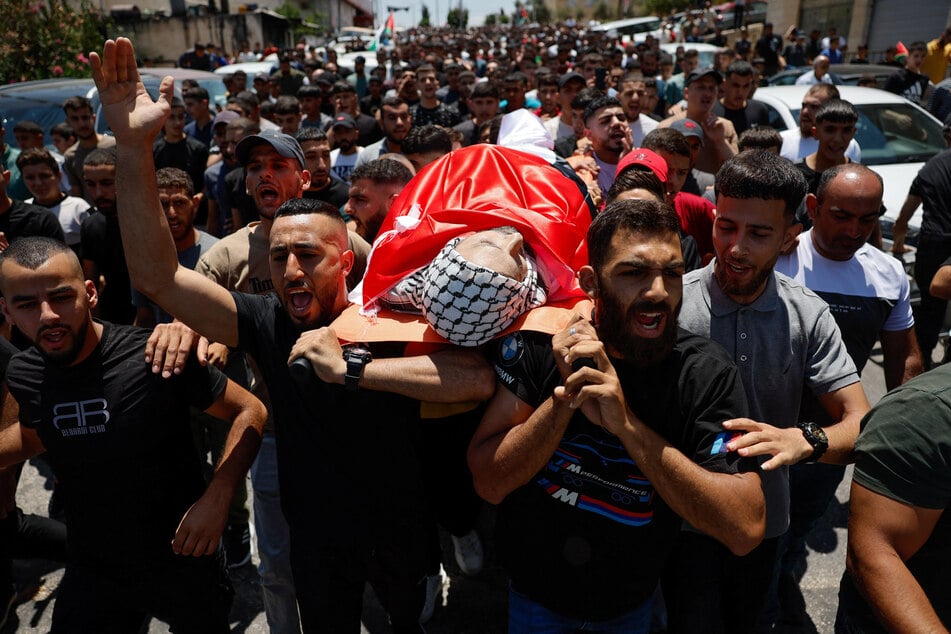 Mourners carry the body of Khamis Ayyad, a Palestinian American who died in an attack by Israeli settlers, during his funeral in Silwad near Ramallah, in the Israeli-occupied West Bank, on August 1, 2025.
