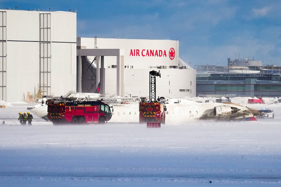 First responders work at the Delta Air Lines plane crash site at Toronto Pearson International Airport in Mississauga, Ontario, Canada.