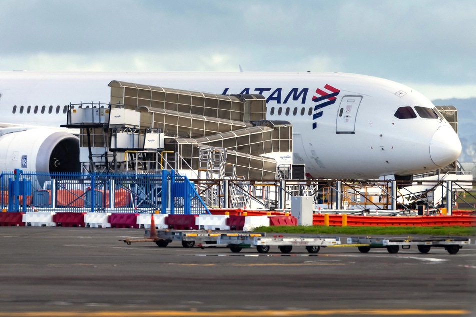 The LATAM Airlines Boeing 787 Dreamliner plane that suddenly lost altitude mid-flight a day earlier, dropping violently and injuring dozens of terrified travelers, is seen on the tarmac of the Auckland International Airport in Auckland on Tuesday.