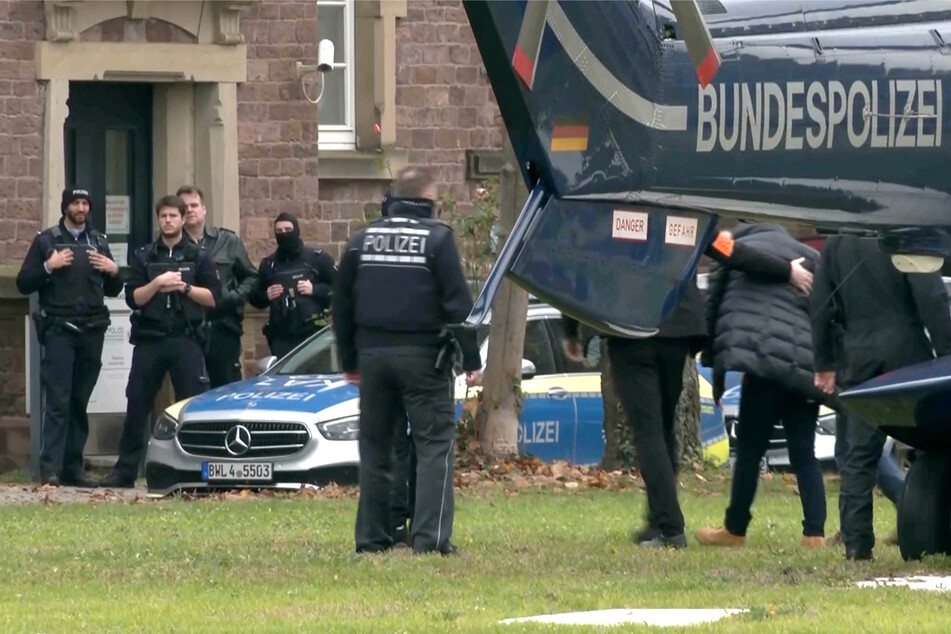 Police escort a detained suspect in the German city of Karlsruhe.