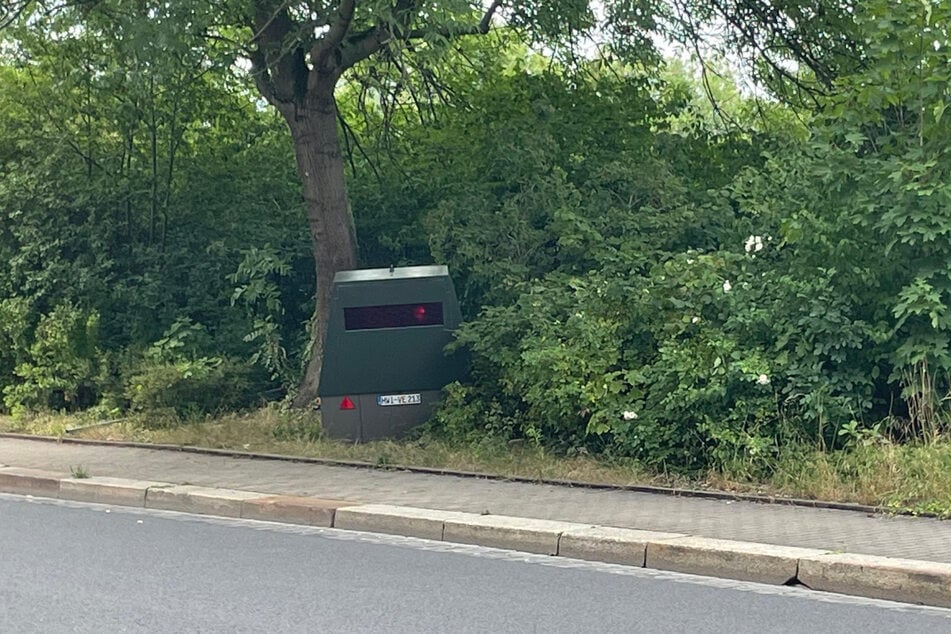 Im Gebüsch kann man den Blitzeranhänger mit dem Kennzeichen HWI-VE-213 leicht übersehen.
