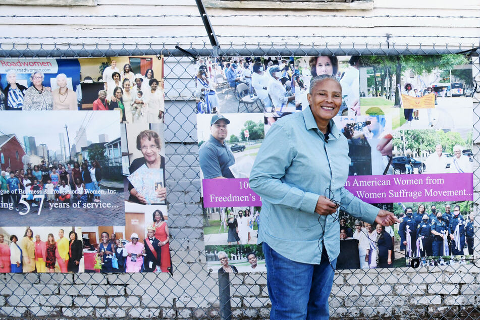 Priscilla Graham stands in front of signs commemorating Freedmen's Town community leaders, past and present.