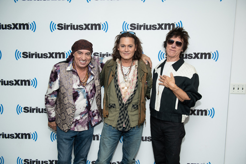 Johnny Depp (c), Steven Van Zandt, and Jeff Beck (r) strike a pose at the SiriusXM Studios, where they promoted Beck and Depp’s new music album.