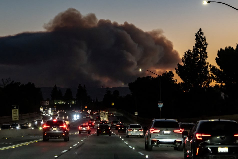 Smoke rises over the hills from the Palisades Fire near Santa Monica, Los Angeles County, California, on January 10, 2025.