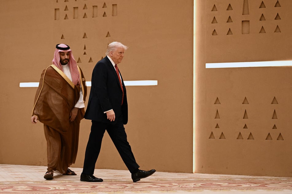 Donald Trump (r.) walks alongside Saudi Crown Prince Mohammed Bin Salman ahead of a group picture with Gulf leaders during the Gulf Cooperation Council summit in Riyadh on May 14, 2025.