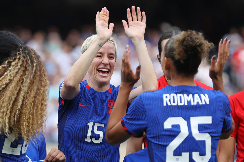 Megan Rapinoe high fives forward Trinity Rodman before the game against South Africa at Soldier Field.