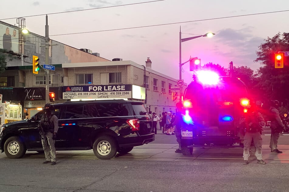 Emergency Task Force vehicles and police officers are seen on the site of a shooting in Toronto, Canada, on July 11, 2026.