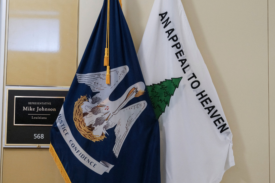 The "Appeal to Heaven" flag (r.) featuring a pine tree on a white background is associated with the January 6, 2021, storming of the Capitol by Trump supporters.