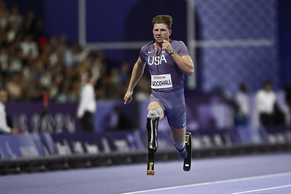 Team USA's Hunter Woodhall competes in the men’s 100m T64 athletic event of the Paris 2024 Paralympic Games at the Stade de France.