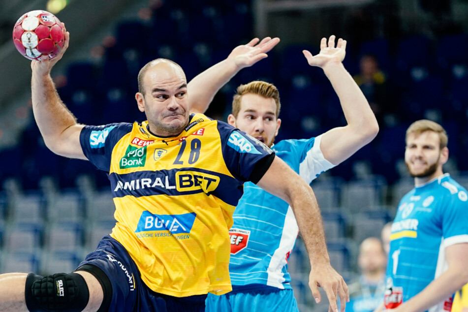 Rafael Baena Gonzalez (l) von den Rhein-Neckar Löwen wirft an Stuttgarts Rudolf Faluvegi vorbei ein Tor. Der Handballverband Baden-Württemberg stellt den Betrieb ein.