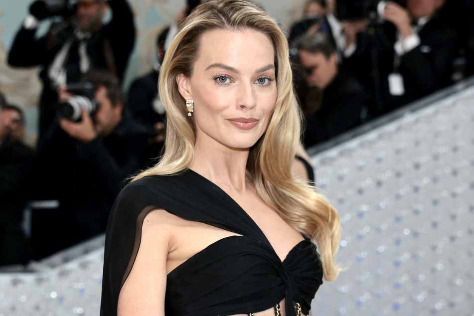 Margot Robbie dished on her role as Barbie and why she had dirty feet while filming Quentin Tarantino's Once Upon a Time in Hollywood.