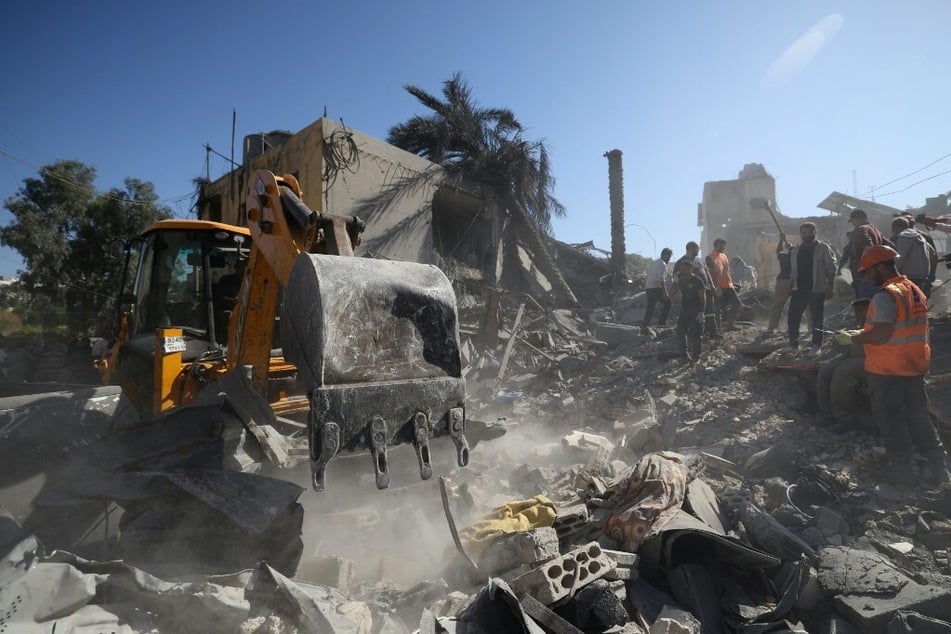 Rescuers search for survivors under the rubble on October 22, 2024, a day after an Israeli airstrike in Beirut's southern suburb of Jnah.