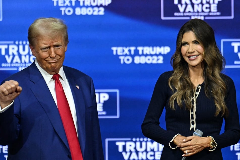 Donald Trump (l.) attends a town hall, moderated by South Dakota Governor Kristi Noem (r.), at the Greater Philadelphia Expo Center and Fairgrounds in Oaks, Pennsylvania, on October 14, 2024.