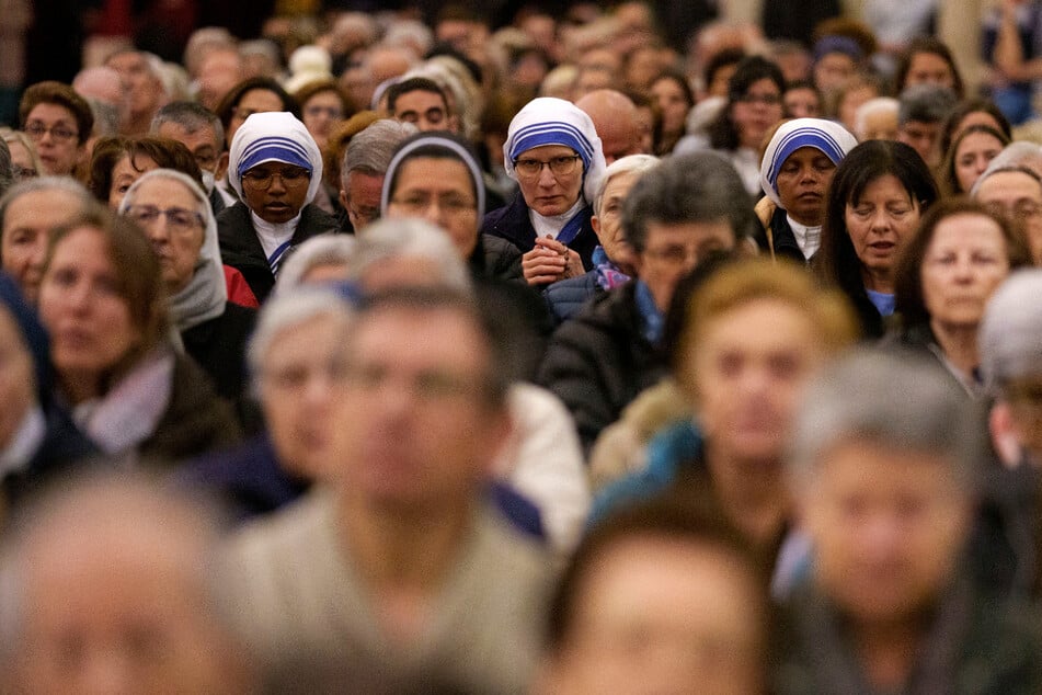 Zahlreiche Menschen beten für Papst Franziskus in der Almudena-Kathedrale in Madrid.