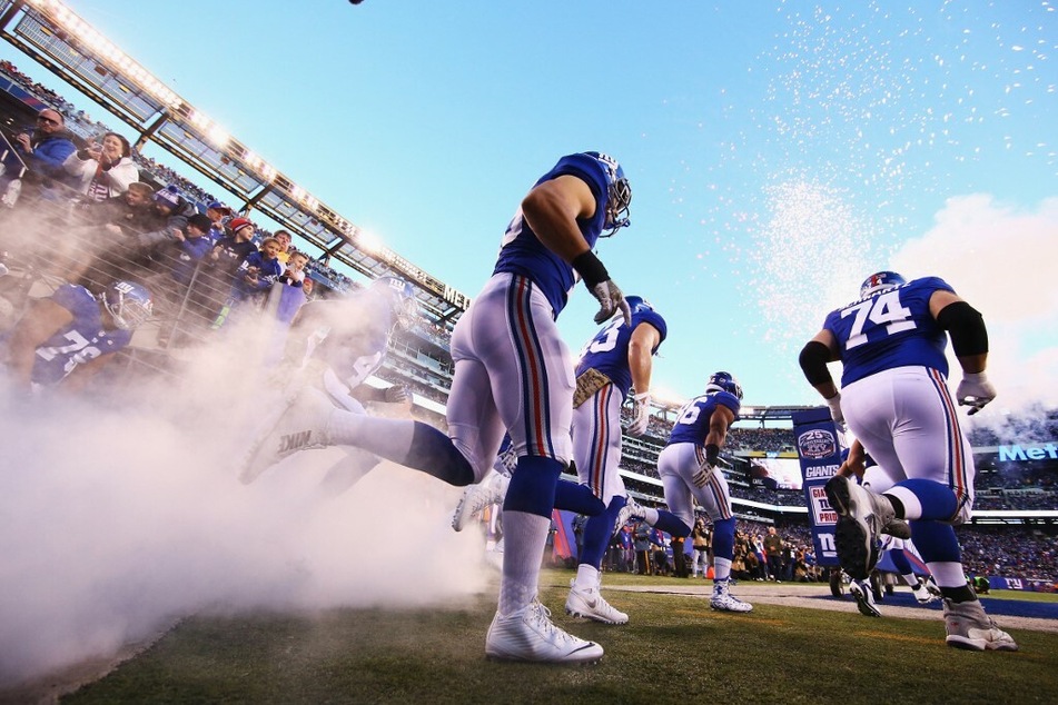 The New York Giants head out to the field to face the New England Patriots in a home game at MetLife Stadium.