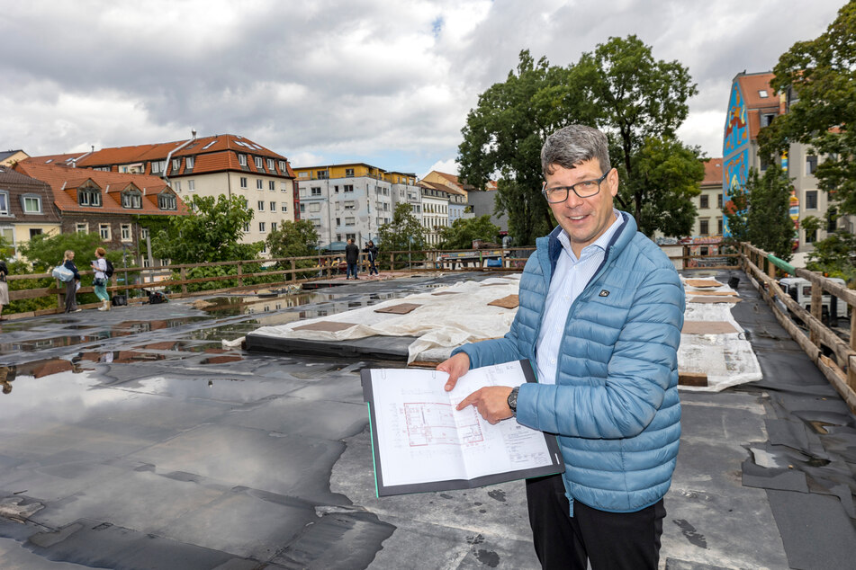 Projektleiter Jens Lerch (51) erläutert die Pläne auf dem Dach der Scheune.