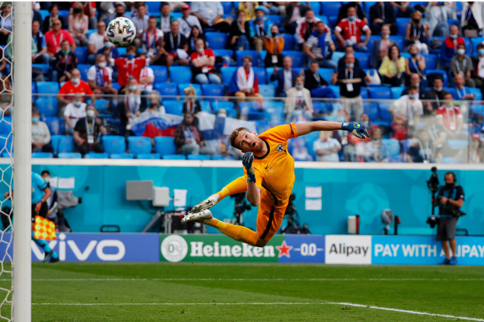 Der finnische Keeper Lukas Hradecky, im Verein bei Bayer 04 Leverkusen aktiv, kann dem wunderschönen Schlenzer von Aleksey Miranchuk nur hinterhergucken.