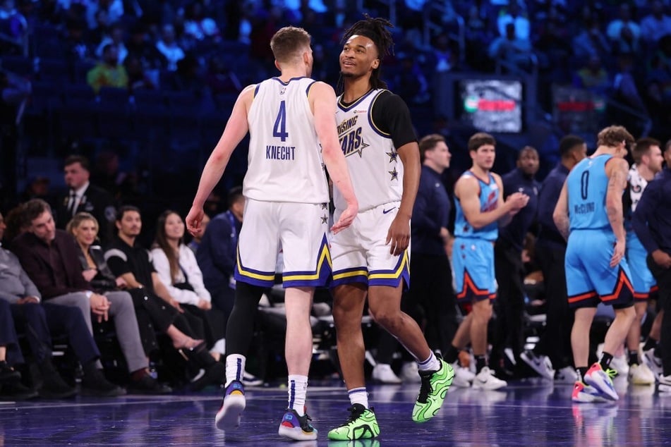 Stephon Castle of the San Antonio Spurs and Dalton Knecht of the Los Angeles Lakers and Team C react during the 2025 NBA All-Star Rising Stars Game at Chase Center.