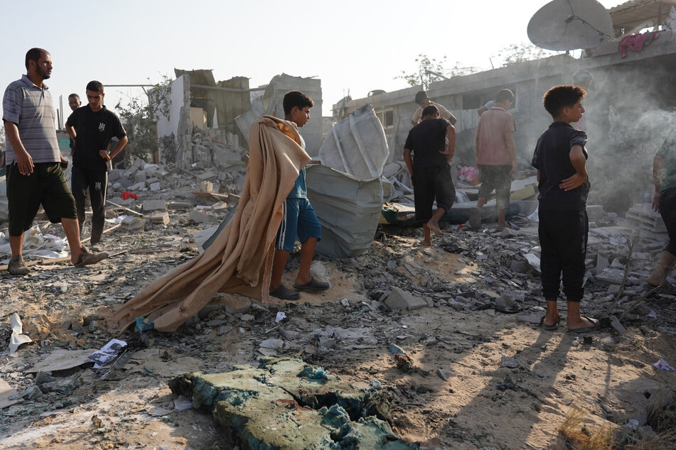 Palestinians inspect the damage following Israeli bombardment on Khan Yunis in the southern Gaza Strip on Tuesday.