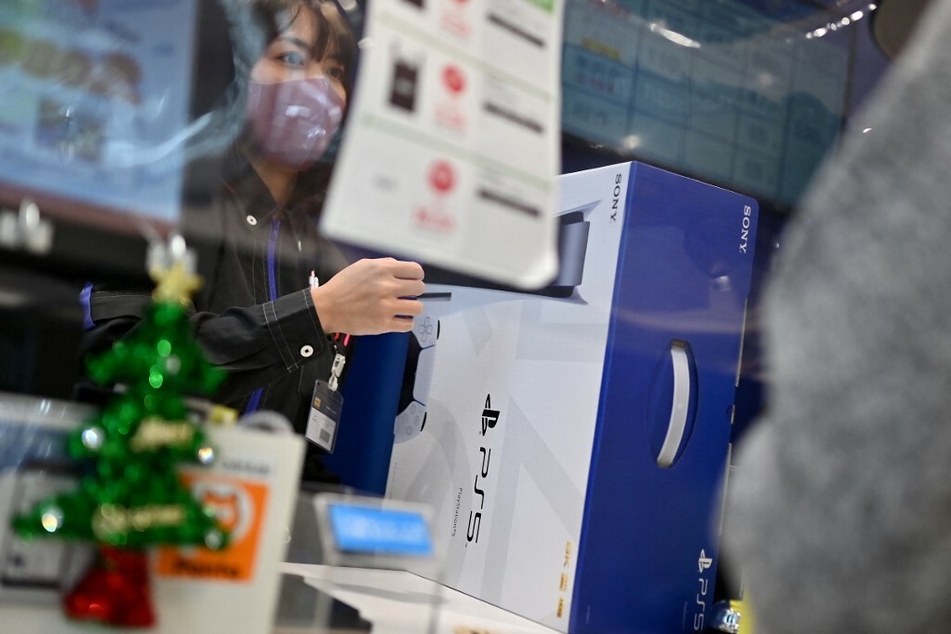 A customer buys the Sony PlayStation 5 gaming console on the first day of its launch.