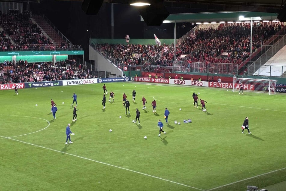 RB Leipzig beginnt die Erwärmung vor dem knackevollen Gästeblock.