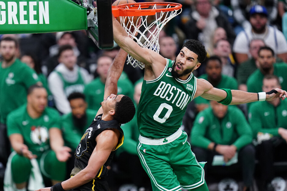 Jayson Tatum (r.) grabbed a career-high 19 rebounds during the Boston Celtics' 121-118 overtime victory against the Golden State Warriors.