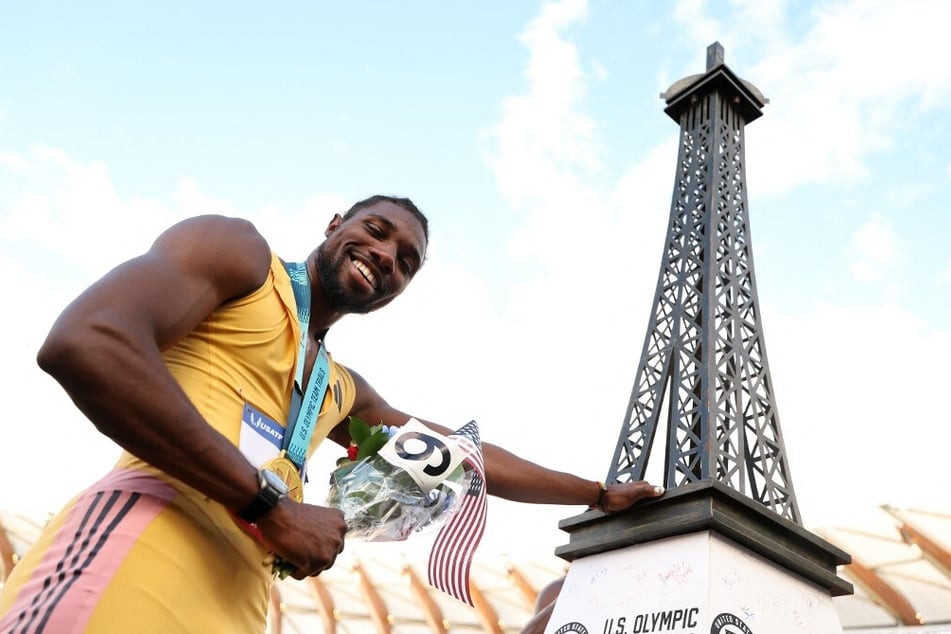 Noah Lyles poses with a miniature Eiffel Tower after winning the men's 200m final at the 2024 US Olympic Team Track &amp; Field Trials.