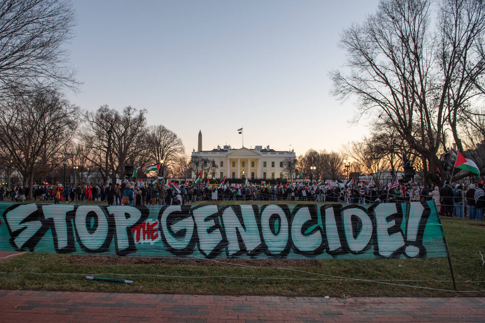 Palestinian rights activists erect a banner reading "Stop the Genocide!" outside the White House as President Joe Biden faces accusations of complicity in Israel's assault on Gaza.
