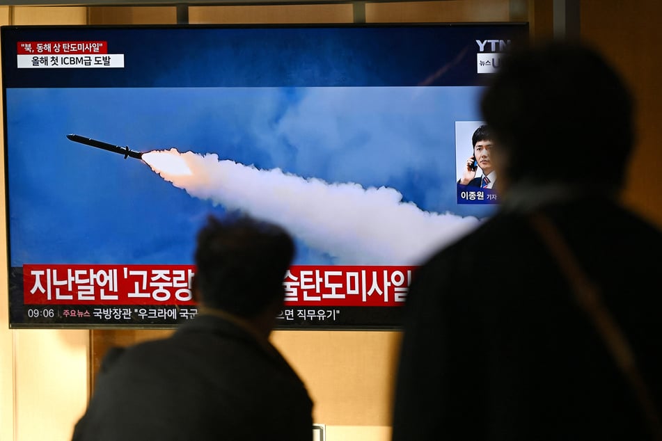 People watch a television screen showing a news broadcast with file footage of a North Korean missile test at a train station in Seoul on Thursday.