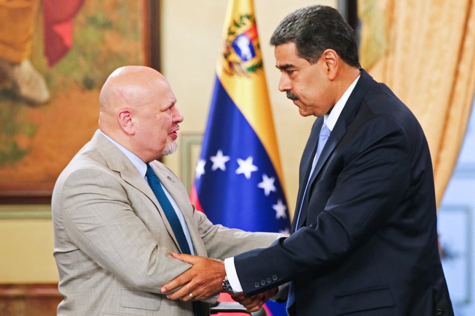 Venezuela's President Nicolas Maduro (r.) shakes hands with International Criminal Court Prosecutor Karim Khan during a television program at the Presidential Palace in Caracas on April 23, 2024.