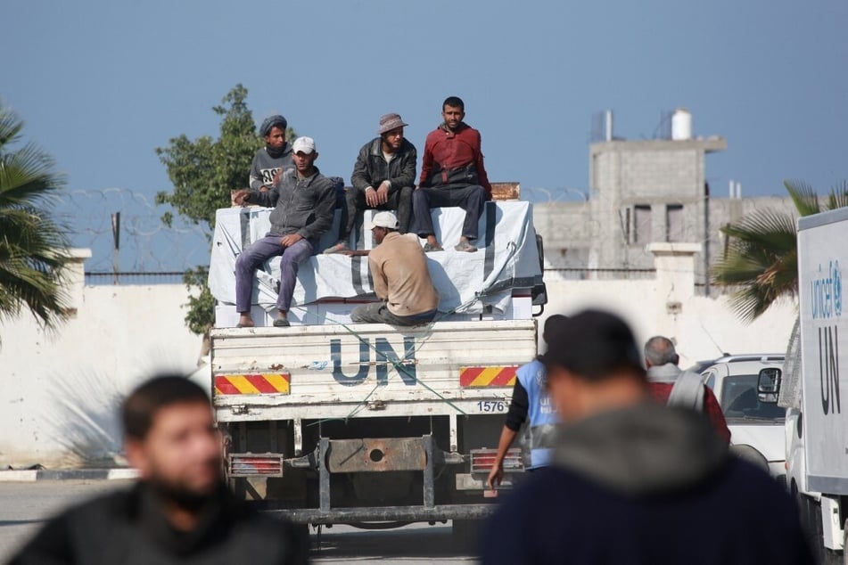 Laborers sit on the back of an UNRWA truck in Khan Younis in the southern Gaza Strip on December 3, 2024.