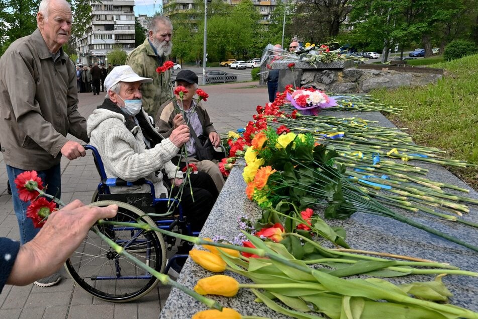 Chernobyl liquidators lay flowers at the Chernobyl memorial in Kyiv on April 26, 2025.