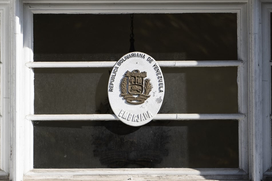 A government seal is posted above a weathered door at the former Venezuelan Embassy in Washington, DC on November 14, 2025.