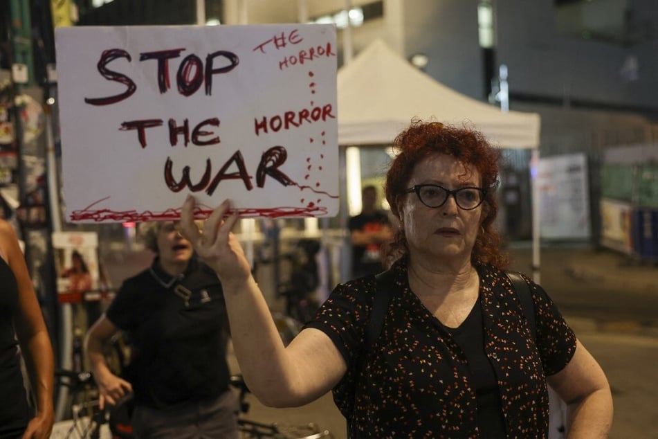 A protester in Tel Aviv holds a sign during a demonstration by supporters and relatives of Israelis held hostage in Gaza since October 7.