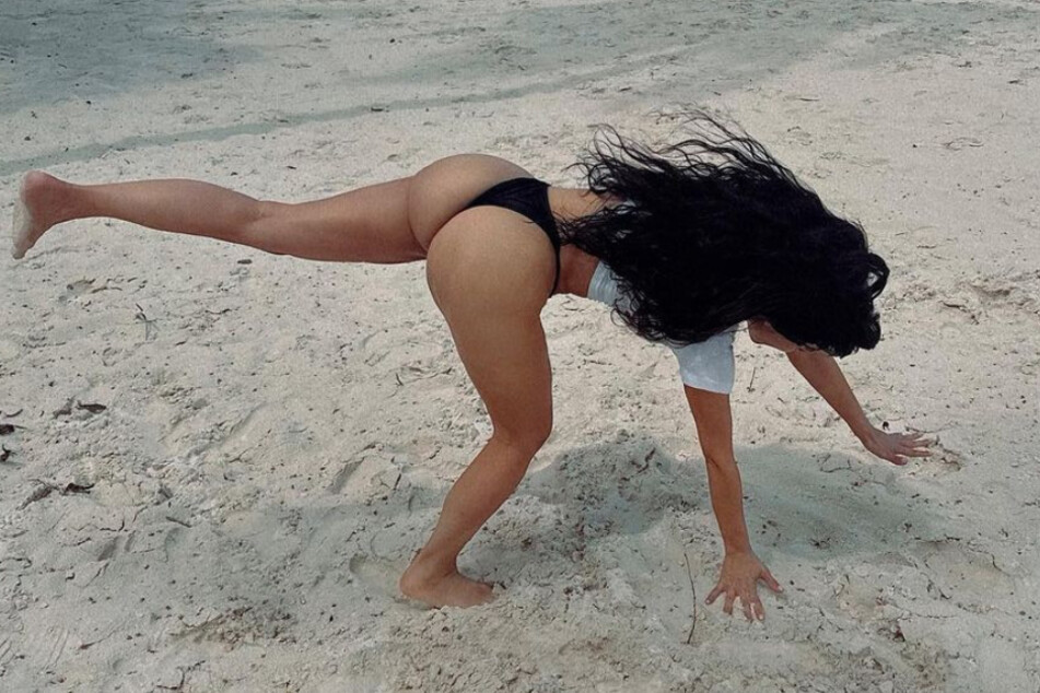 Kim Kardashian (42) schlägt ein Rad am Strand.