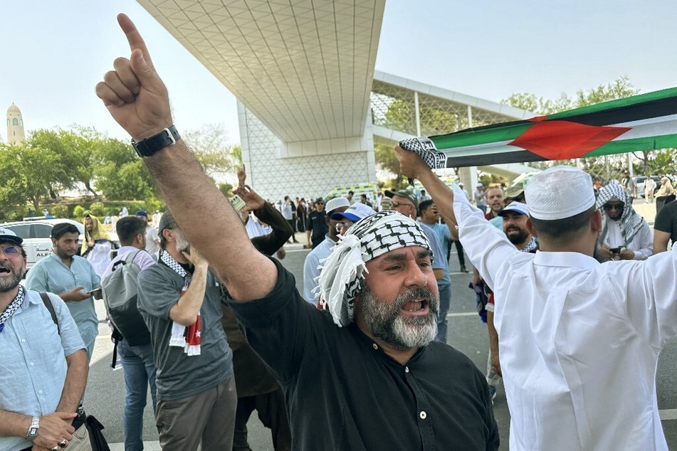 Mourners shout slogans close to the Imam Muhammad bin Abdul Wahhab Mosque in Qatar during the final prayers for Ismail Haniyeh, Hamas' assassinated political leader.