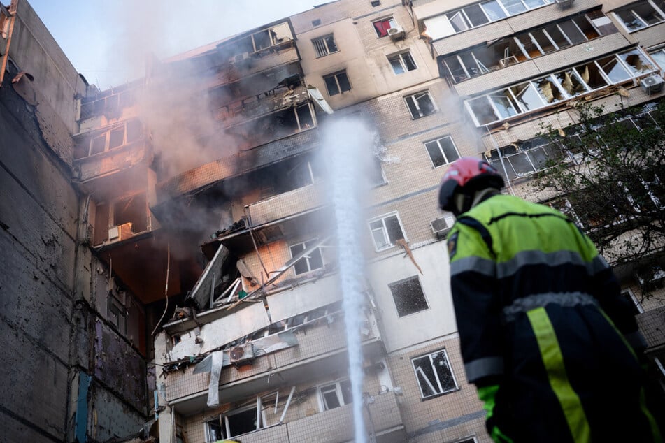 A firefighter works at a heavily damaged residential building following Russian drone and missile strikes in Kyiv on September 7, 2025.