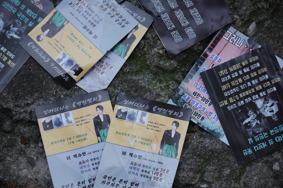 North Korean propaganda leaflets denouncing South Korean President Yoon Suk Yeol and his wife Kim Keon Hee, apparently carried by balloons sent from North Korea, lie on the ground near the Presidential Office in Seoul.